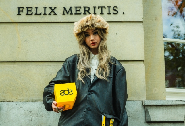 hip meisje die ADE logo vasthoudt