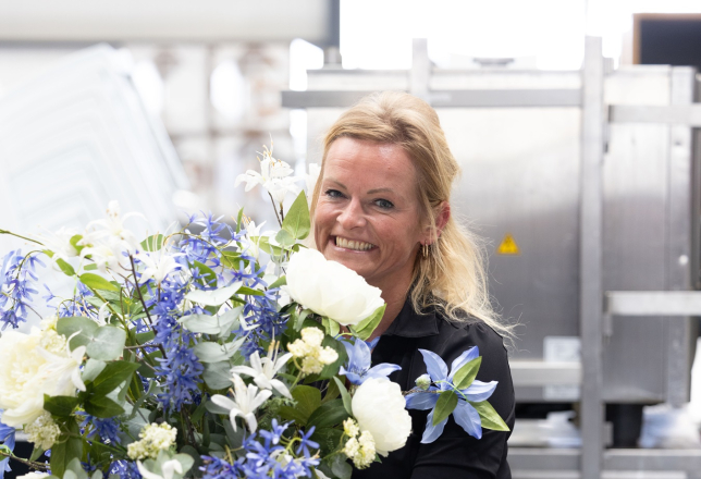 Vrouw met grote vaas met bloemen